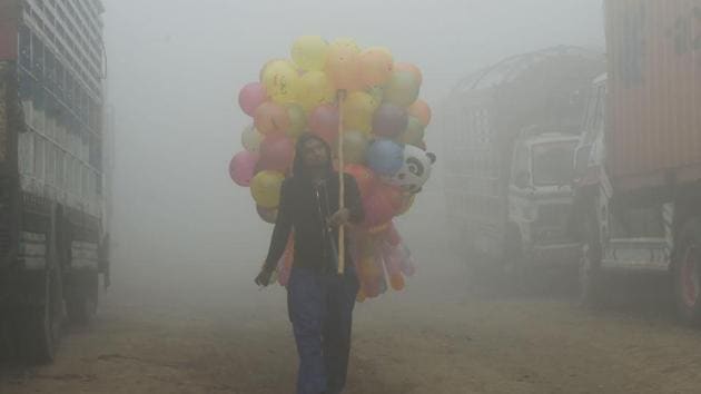 A Pakistani vendor carries balloons on a street amid heavy smog in Lahore. NOAA released satellite pictures and explained the reasons behind such a polluting atmosphere in major parts of north India and Pakistan.(AFP File Photo) A Pakistani vendor carries balloons on a street amid heavy smog in Lahore. NOAA released satellite pictures and explained the reasons behind such a polluting atmosphere in major parts of north India and Pakistan.(AFP File Photo)