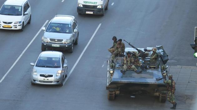 A military tank is seen with armed soldiers outside President Robert Mugabe's office in Harare. (AP Photo) A military tank is seen with armed soldiers outside President Robert Mugabe's office in Harare. (AP Photo)