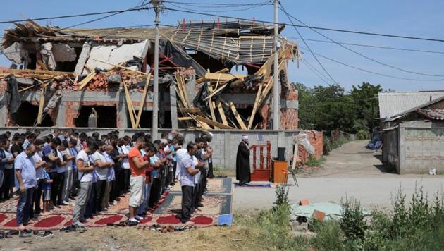 Muslims pray on a street in front of a mosque which was demolished in the district of Zemun Polje in Belgrade, Serbia. The mosque’s ruins and rows of worshippers lined outside, represent the efforts of around 20,000 Muslims in the Serbian capital to gather for worship in a city which is overwhelmingly Orthodox Christian. The community claims authorities have blocked mosque construction in the region. (Marko Djurica / REUTERS) Muslims pray on a street in front of a mosque which was demolished in the district of Zemun Polje in Belgrade, Serbia. The mosque’s ruins and rows of worshippers lined outside, represent the efforts of around 20,000 Muslims in the Serbian capital to gather for worship in a city which is overwhelmingly Orthodox Christian. The community claims authorities have blocked mosque construction in the region. (Marko Djurica / REUTERS)