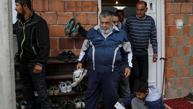 Men collect their shoes after Friday prayers at a temporary mosque in the district of Sremcica in Belgrade. Mufti Muhamed Hamdi Jusufspahic, head of the Supreme Assembly of the Islamic Community of Serbia told Reuters that they have sought permits for a number of locations, for decades but eventually never reached a point of even qualifying to submit papers. (REUTERS) Men collect their shoes after Friday prayers at a temporary mosque in the district of Sremcica in Belgrade. Mufti Muhamed Hamdi Jusufspahic, head of the Supreme Assembly of the Islamic Community of Serbia told Reuters that they have sought permits for a number of locations, for decades but eventually never reached a point of even qualifying to submit papers. (REUTERS)