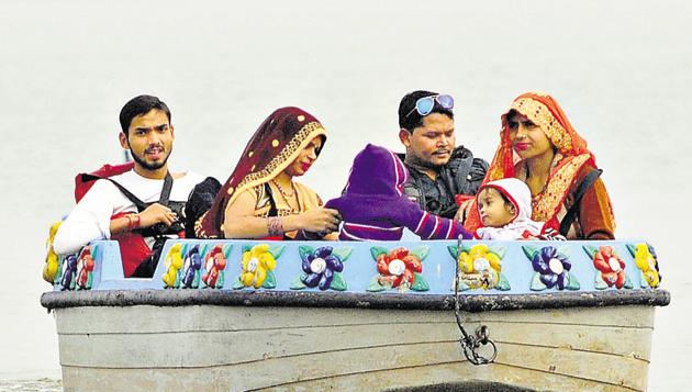 The cold weather is no dampener for people as they take to boating at the lake in Chandigarh. (Anil Dayal/HT)