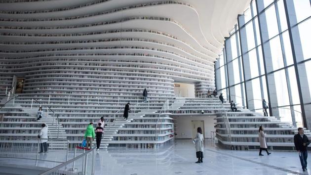 The library has another quirk: Its irregular white stairs have proven hazardous for selfie-snappers with eyes glued down to their phones or up at the stylish ceiling. “People trip a lot. Last week an old lady slipped and hit her head hard. There was blood,” said one guard, who yells warnings at visitors. (Fred Dufour / AFP) The library has another quirk: Its irregular white stairs have proven hazardous for selfie-snappers with eyes glued down to their phones or up at the stylish ceiling. “People trip a lot. Last week an old lady slipped and hit her head hard. There was blood,” said one guard, who yells warnings at visitors. (Fred Dufour / AFP)