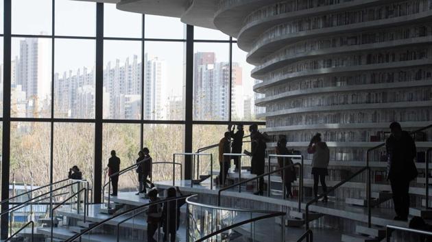 Sustaining membership however may prove difficult in a country where readers increasingly flip through novels on smartphones. “I don’t usually touch real books,” Yuan Jiwen, a visitor said, holding an unread paperback as a prop while he people-watched in the atrium. “But it feels appropriate to be holding one here.” (Fred Dufour / AFP) Sustaining membership however may prove difficult in a country where readers increasingly flip through novels on smartphones. “I don’t usually touch real books,” Yuan Jiwen, a visitor said, holding an unread paperback as a prop while he people-watched in the atrium. “But it feels appropriate to be holding one here.” (Fred Dufour / AFP)