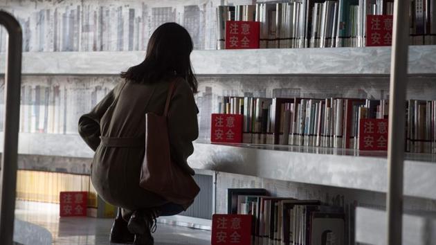 But readers expecting to pluck tomes from its terraced shelves are in for a surprise. Most books are in other rooms with more classic library bookshelves. “There’s quite a big difference between the photos and reality,” said Jiang Xue, a 21-year-old medical student left perusing one of the more robustly stocked sections: propaganda about the ruling Communist Party’s recent congress. (Fred Dufour / AFP) But readers expecting to pluck tomes from its terraced shelves are in for a surprise. Most books are in other rooms with more classic library bookshelves. “There’s quite a big difference between the photos and reality,” said Jiang Xue, a 21-year-old medical student left perusing one of the more robustly stocked sections: propaganda about the ruling Communist Party’s recent congress. (Fred Dufour / AFP)