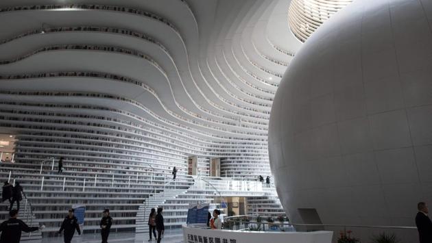 The original concept was for the upper bookshelves to be accessible via rooms behind the atrium, but a fast-tracked schedule forced MVRDV to drop the idea. Liu Xiufeng, the library’s deputy director says the final plans stated that the atrium would be used for circulation, sitting, reading, and discussion, but omitted a key request to store books on shelves. (Fred Dufour / AFP) The original concept was for the upper bookshelves to be accessible via rooms behind the atrium, but a fast-tracked schedule forced MVRDV to drop the idea. Liu Xiufeng, the library’s deputy director says the final plans stated that the atrium would be used for circulation, sitting, reading, and discussion, but omitted a key request to store books on shelves. (Fred Dufour / AFP)
