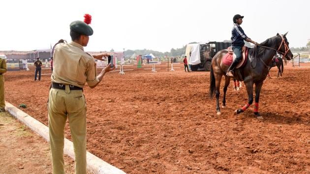 A NCC cadet takes picture of the horse rider at the Southern Star Horse Show-2017 in Pune. (Sanket Wankhade/HT PHOTO) 