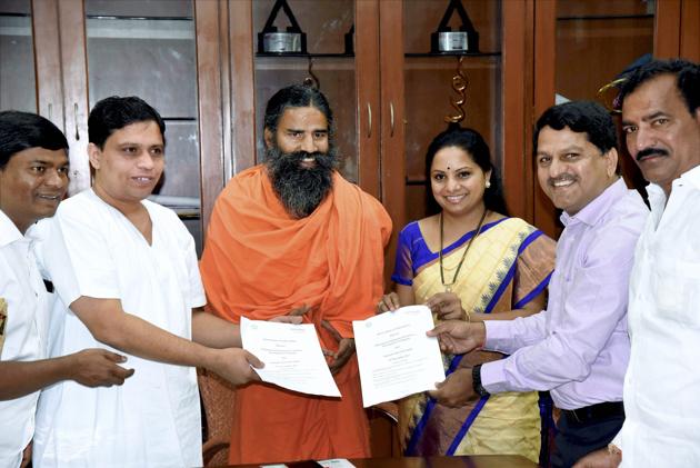 TRS MP K Kavitha, accompanied by a delegation, meets Yoga guru Ramdev and Acharya Balakrishna in Haridwar . Patanjali group will make investments to the tune of ₹1000 crore in Telangana. (PTI) TRS MP K Kavitha, accompanied by a delegation, meets Yoga guru Ramdev and Acharya Balakrishna in Haridwar . Patanjali group will make investments to the tune of ₹1000 crore in Telangana. (PTI)