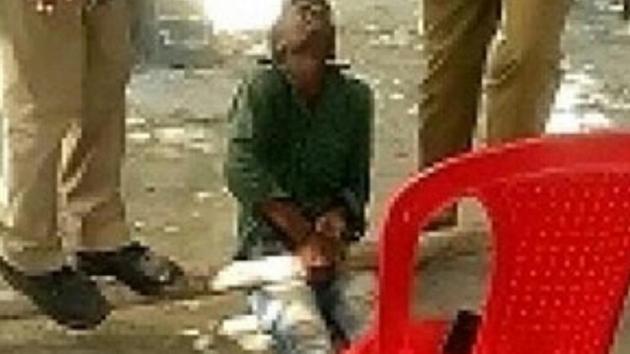 A video grab shows policemen standing on a bamboo placed on a boy’s legs A video grab shows policemen standing on a bamboo placed on a boy’s legs