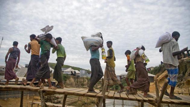 Rohingya Muslims, who crossed over from Myanmar into Bangladesh, walk on a bridge at Kutupalong refugee camp in Ukhiya, Bangladesh, Wednesday, Nov. 15, 2017. (AP) Rohingya Muslims, who crossed over from Myanmar into Bangladesh, walk on a bridge at Kutupalong refugee camp in Ukhiya, Bangladesh, Wednesday, Nov. 15, 2017. (AP)