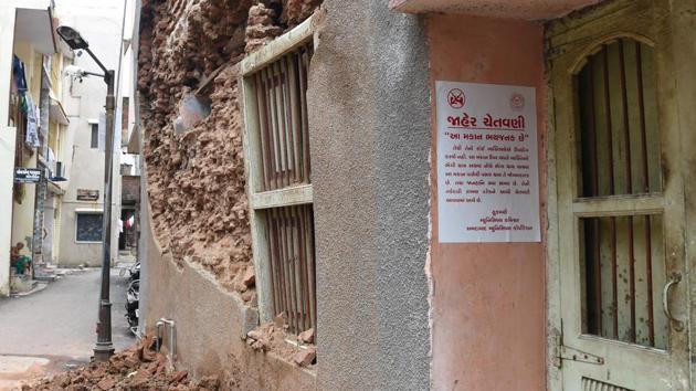 A Gujarati language warning notice related to a structurally damaged old heritage building seen in Ahmedabad. Authorities hope recognition from the UN’s cultural body will restore community pride in the but many families that once fastidiously tended to ornate wooden homes in the old city are leaving in droves for the comforts of the modern city outside, tired of shabby living conditions. (Sam Panthaky / AFP) A Gujarati language warning notice related to a structurally damaged old heritage building seen in Ahmedabad. Authorities hope recognition from the UN’s cultural body will restore community pride in the but many families that once fastidiously tended to ornate wooden homes in the old city are leaving in droves for the comforts of the modern city outside, tired of shabby living conditions. (Sam Panthaky / AFP)