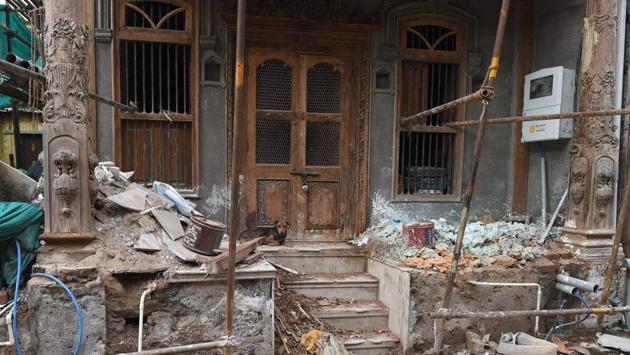 A stray dog sits outside the construction site of an old heritage building under renovation in Ahmedabad. Some long-neglected quarters, sealed off from the outside world by labyrinthine alleys, are well beyond restoration. Many traditional ‘pols’ -- clusters of settlements identified by UNESCO as bearing “enormous” historical value are all but abandoned, the iconic wooden homes collapsing from neglect. (Sam Panthaky / AFP) A stray dog sits outside the construction site of an old heritage building under renovation in Ahmedabad. Some long-neglected quarters, sealed off from the outside world by labyrinthine alleys, are well beyond restoration. Many traditional ‘pols’ -- clusters of settlements identified by UNESCO as bearing “enormous” historical value are all but abandoned, the iconic wooden homes collapsing from neglect. (Sam Panthaky / AFP)