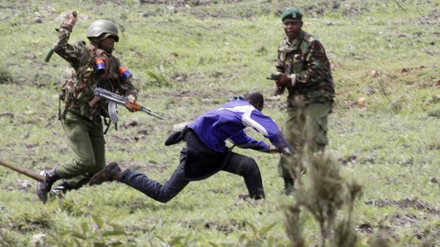 Kenya riot police chase and prepare to strike a supporter of Kenyan opposition National Super Alliance (NASA) coalition in Nairobi, Kenya. (Khalil Senosi / AP)
