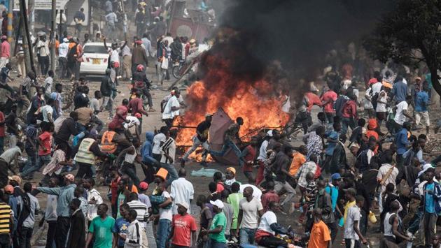 Supporters of Kenyan's opposition party react following the sound of gunshots during a demonstration in Nairobi. Supporters had earlier accused police of stopping them at the main highway from going to the airport to greet Odinga. The confrontations were aired on live television. (Yasuyoshi Chiba / AFP)