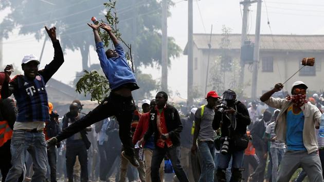 A supporter of NASA tries to catch a tear-gas fired by anti-riot police during the clashes in Kenya. Odinga had been speaking in the US and Britain about the country’s political turmoil following the nullification of presidential election last month. He boycotted the new vote, saying reforms had not been made. (Thomas Mukoya / REUTERS)