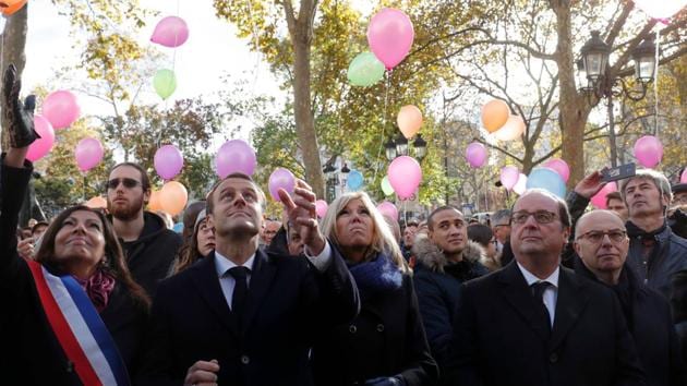 (From L) Mayor of Paris Anne Hidalgo, French President Emmanuel Macron, his wife Brigitte, former French President Francois Hollande and former Interior Minister Bernard Cazeneuve release balloons at Paris 11th district town hall on November 13, 2017, during a ceremony marking the second anniversary of the Paris attacks of November 2015. (Philippe Wojazer / AFP) 