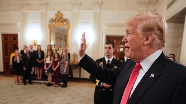 US President Donald Trump arrives in the State Dining Room during an event honoring the NCAA national championship teams on November 17, 2017 in Washington, DC. (AFP Photo) US President Donald Trump arrives in the State Dining Room during an event honoring the NCAA national championship teams on November 17, 2017 in Washington, DC. (AFP Photo)