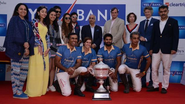 Achievers team players celebrate with the trophy after beating Delhiites Polo in the final of the Indian Masters Polo in New Delhi on Sunday.(HT Photo)