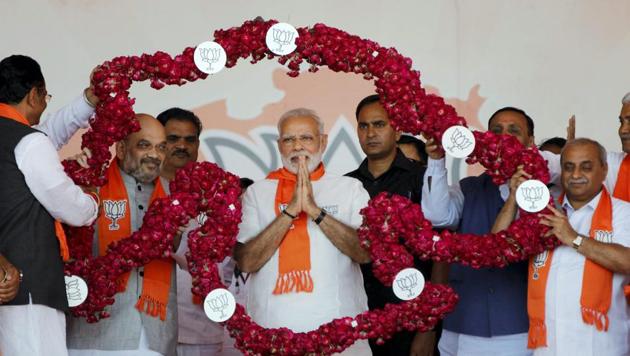 Prime Minister Narendra Modi and BJP president Amit Shah being garlanded during “Gujarat Gaurav Mahasammelan” in Ahmedabad. (PTI FILE) Prime Minister Narendra Modi and BJP president Amit Shah being garlanded during “Gujarat Gaurav Mahasammelan” in Ahmedabad. (PTI FILE)