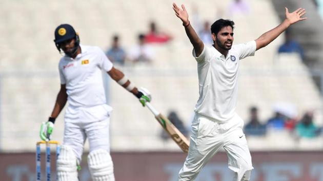 Indian cricket team's Bhuvneshwar Kumar (R) celebrates the wicket of Sri Lanka cricket team's Dasun Shanaka during the fourth day of the first Test at the Eden Gardens cricket stadium in Kolkata on Saturday. (AFP) Indian cricket team's Bhuvneshwar Kumar (R) celebrates the wicket of Sri Lanka cricket team's Dasun Shanaka during the fourth day of the first Test at the Eden Gardens cricket stadium in Kolkata on Saturday. (AFP)