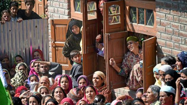 Village women watch the funeral procession of Nasrullah Mir, a militant who was killed in an encounter at Hajin in Bandipora district, Kashmir on Wednesday.(PTI Photo) Village women watch the funeral procession of Nasrullah Mir, a militant who was killed in an encounter at Hajin in Bandipora district, Kashmir on Wednesday.(PTI Photo)
