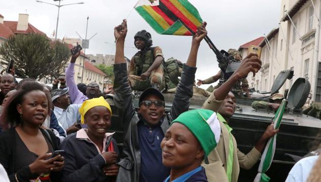 Protesters calling for Zimbabwean President Robert Mugabe’s resignation cheer in front of a military vehicle in Harare, Zimbabwe. (REUTERS) Protesters calling for Zimbabwean President Robert Mugabe’s resignation cheer in front of a military vehicle in Harare, Zimbabwe. (REUTERS)