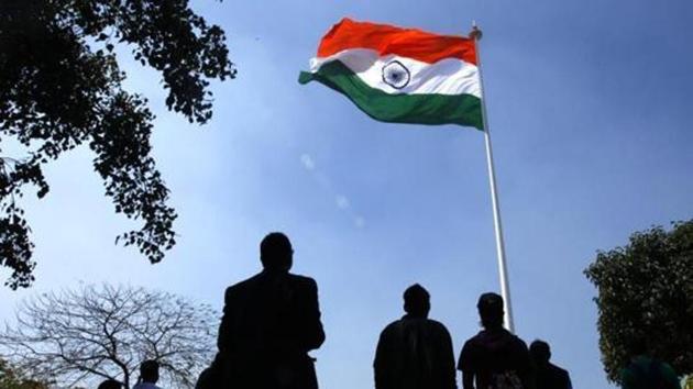 People stand as the national anthem is played during the hoisting of the highest monumental national flag in New Delhi. (File) People stand as the national anthem is played during the hoisting of the highest monumental national flag in New Delhi. (File)