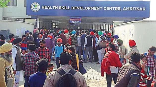 Candidates waiting outside the skill development centre in Amritsar on Sunday. (HT Photo) Candidates waiting outside the skill development centre in Amritsar on Sunday. (HT Photo)