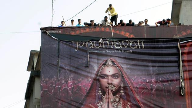 Members of the Akhil Bhartiya Chatriya Mahasabha dismantle a poster of the movie ‘Padmavati’ in protest in Ranchi, on November 12, 2017. They have raised objections to the portrayal of Rani Padmavati, a Rajput queen on whom the character is based, in the movie.(Diwakar Prasad/ HT File Photo)