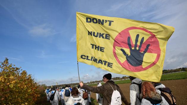 Environmentalist march close to the Hambach lignite open pit mine near Elsdorf, Germany, on November 5, 2017, as they protest against fossil-based energies like coal, having negative impact on the climate change (AFP) Environmentalist march close to the Hambach lignite open pit mine near Elsdorf, Germany, on November 5, 2017, as they protest against fossil-based energies like coal, having negative impact on the climate change (AFP)