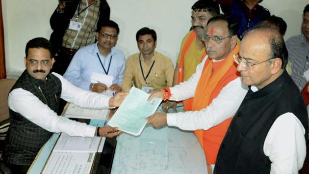 Gujarat chief minister Vijay Rupani files his nomination papers for the state assembly election, in presence of finance minister Arun Jaitley in Rajkot.(PTI Photo)