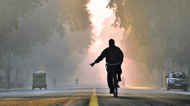 New Delhi, India - Nov. 18, 2017: A man cycles, early morning after late night drizzling helped to lower the smog and pollution level, at Crescent road in New Delhi, India, on Saturday, November 18, 2017. (Photo by Sanchit Khanna/ Hindustan Times) (Sanchit Khanna/HT PHOTO) New Delhi, India - Nov. 18, 2017: A man cycles, early morning after late night drizzling helped to lower the smog and pollution level, at Crescent road in New Delhi, India, on Saturday, November 18, 2017. (Photo by Sanchit Khanna/ Hindustan Times) (Sanchit Khanna/HT PHOTO)
