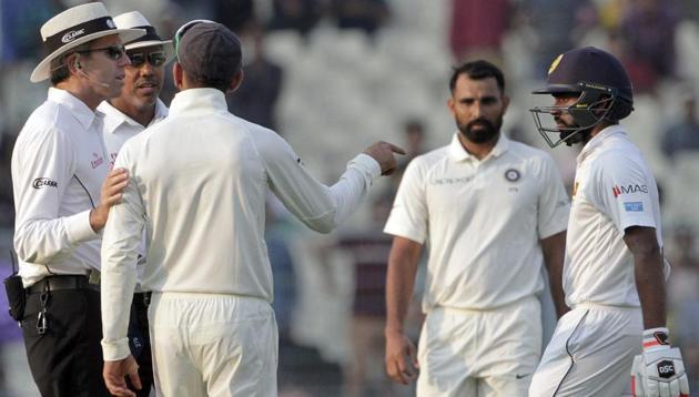 India captain Virat Kohli, back to camera, talks to the umpires after he felt that Sri Lanka's Niroshan Dickwella was intentionally delaying play in the first Test. (AP) India captain Virat Kohli, back to camera, talks to the umpires after he felt that Sri Lanka's Niroshan Dickwella was intentionally delaying play in the first Test. (AP)