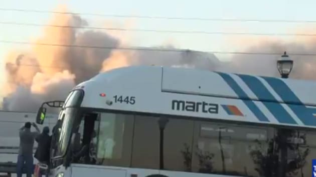 Video screengrab shows the moment the bus blocked the footage of a stadium being demolished in Georgia.