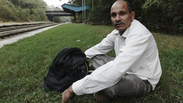Tilak Raj, a daily commuter of the Ring Railway, poses for a portrait outside the S P Marg Ring Railway Station in New Delhi. “It was a good mode of transport until the mid- 1990s, when it started going off track. The stations were better, the trains more frequent, the commuters more civilized. But then the government lost interest, the city spread, and the passengers drifted to buses that provided last-mile connectivity,” he said. (Vipin Kumar / HT Photo) 