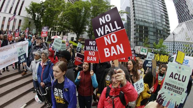 Protesters wave signs and chant during a demonstration against US President Donald Trump's revised travel ban, outside a federal courthouse in Seattle in June. (AP file) Protesters wave signs and chant during a demonstration against US President Donald Trump's revised travel ban, outside a federal courthouse in Seattle in June. (AP file)