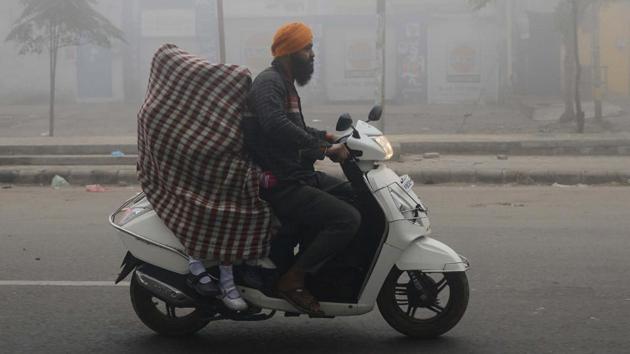Indian schoolgirls are covered in a sheet in an effort to protect themselves from heavy smog as they are driven to school on a scooter after three days off due to the air pollution in Amritsar on November 13, 2017. Large swathes of north India and Pakistan see a spike in pollution at the onset of winter due to crop burning and the fact that cooler air traps particulates close to the ground, preventing them from dispersing -- a phenomenon known as inversion. (AFP) Indian schoolgirls are covered in a sheet in an effort to protect themselves from heavy smog as they are driven to school on a scooter after three days off due to the air pollution in Amritsar on November 13, 2017. Large swathes of north India and Pakistan see a spike in pollution at the onset of winter due to crop burning and the fact that cooler air traps particulates close to the ground, preventing them from dispersing -- a phenomenon known as inversion. (AFP)