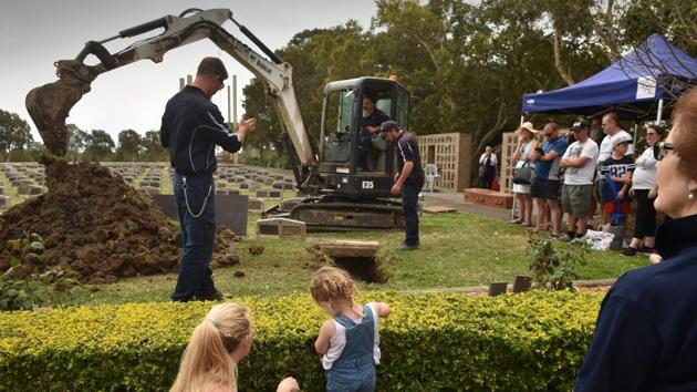 Visitors watch grave digging demonstrations during the 150th anniversary open day at Rookwood--the largest cemetery in the southern hemisphere-- in Sydney. By reinventing cemeteries as unexplored, lush, green spaces in the heart of crowded cities, authorities hope to challenge taboos surrounding death while breathing new life into the usually sombre grounds. (Peter Parks / AFP) Visitors watch grave digging demonstrations during the 150th anniversary open day at Rookwood--the largest cemetery in the southern hemisphere-- in Sydney. By reinventing cemeteries as unexplored, lush, green spaces in the heart of crowded cities, authorities hope to challenge taboos surrounding death while breathing new life into the usually sombre grounds. (Peter Parks / AFP)