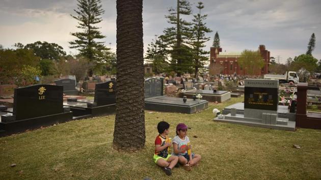 Visitors sit surrounded by gravestones at Rookwood cemetery. With death rates in Australia set to more than double over the next few decades as the population ages, more and more people are going to be confronted by their own mortality, if not those of relatives and friends, Pitt says. (Peter Parks / AFP) Visitors sit surrounded by gravestones at Rookwood cemetery. With death rates in Australia set to more than double over the next few decades as the population ages, more and more people are going to be confronted by their own mortality, if not those of relatives and friends, Pitt says. (Peter Parks / AFP)