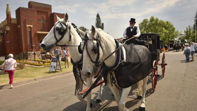 A vintage horse-drawn hearse is driven past a mausoleum during an open day at Rookwood in Sydney. The cemeteries authority has also organised “Death Over Dinner” events --where guests share a meal and ask expert speakers about the end of life-- to normalise discussions around dying. (Peter Parks / AFP) A vintage horse-drawn hearse is driven past a mausoleum during an open day at Rookwood in Sydney. The cemeteries authority has also organised “Death Over Dinner” events --where guests share a meal and ask expert speakers about the end of life-- to normalise discussions around dying. (Peter Parks / AFP)