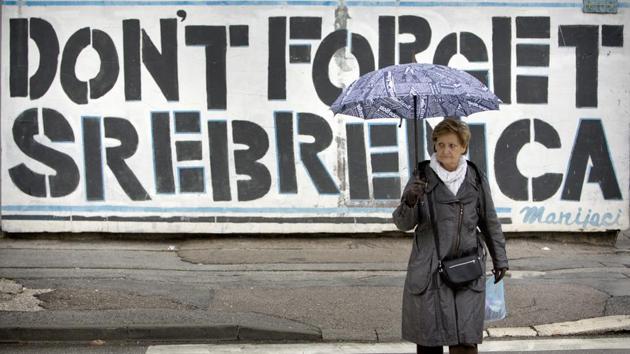 A woman crosses a street backdropped by a large Srebrenica remembrance graffiti, in Sarajevo, Bosnia. For survivors such as Fikret Bacic, Mladic is already dead. “The only thing that interests me is finding my wife, my children, my mother,” he told AFP. Six-year-old Nermina, 12-year-old Nermin and their mother Minka were executed by Bosnian Serb forces. They remain among some 7,000 people still missing in Bosnia. (Amel Emric / AP) A woman crosses a street backdropped by a large Srebrenica remembrance graffiti, in Sarajevo, Bosnia. For survivors such as Fikret Bacic, Mladic is already dead. “The only thing that interests me is finding my wife, my children, my mother,” he told AFP. Six-year-old Nermina, 12-year-old Nermin and their mother Minka were executed by Bosnian Serb forces. They remain among some 7,000 people still missing in Bosnia. (Amel Emric / AP)