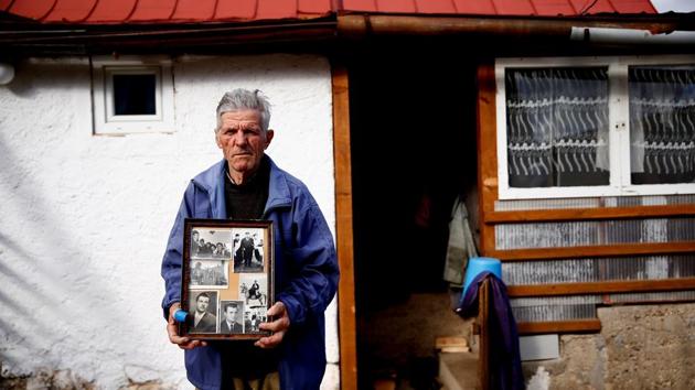 Mile Mladic, a cousin of the former commander Ratko Mladic, holds old family photos of Ratko Mladic and family in front of his home in Bozanovici. "I would be happiest if he died before the judgement," said Mile. "We would then raise a large monument for him in the village and write the truth. All this that is happening is not the truth. It is a lie. The general is not guilty." (Dado Ruvic / REUTERS) Mile Mladic, a cousin of the former commander Ratko Mladic, holds old family photos of Ratko Mladic and family in front of his home in Bozanovici. "I would be happiest if he died before the judgement," said Mile. "We would then raise a large monument for him in the village and write the truth. All this that is happening is not the truth. It is a lie. The general is not guilty." (Dado Ruvic / REUTERS)