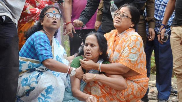 Women console a relative of the senior journalist who was killed in a firing by Tripura State Rifles jawan, in Agartala on Tuesday.(PTI Photo)