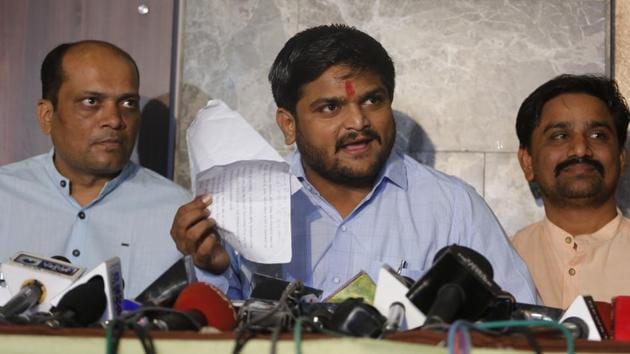 Hardik Patel with Dinesh Bhambaniya (L) addresses a press conference in Ahmedabad on Wednesday.(Siddharaj Solanki/HT Photo)