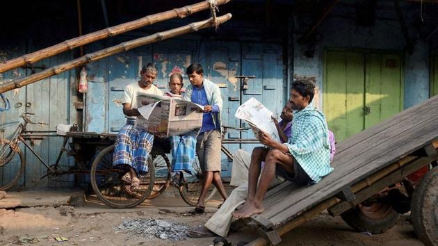 Daily wage workers read newspapers as a strike called by BJP and Congress party hit normal life in Agartala. Barring ‘Daily Desher Katha’, all other newspapers left their editorial columns blank today in protest against the killing. This is the second instance of a journalist being killed in the state in recent months. (PTI) Daily wage workers read newspapers as a strike called by BJP and Congress party hit normal life in Agartala. Barring ‘Daily Desher Katha’, all other newspapers left their editorial columns blank today in protest against the killing. This is the second instance of a journalist being killed in the state in recent months. (PTI)