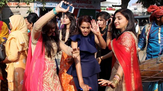 Family members and relatives dance during the marriage procession in Meerut on Thursday. (PTI)