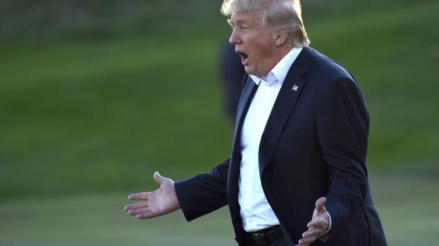 President Donald Trump reacts as he walks over to participate in presenting the Presidents Cup to the United States team at the Jersey City Golf Club in Jersey City. (AP File Photo) President Donald Trump reacts as he walks over to participate in presenting the Presidents Cup to the United States team at the Jersey City Golf Club in Jersey City. (AP File Photo)