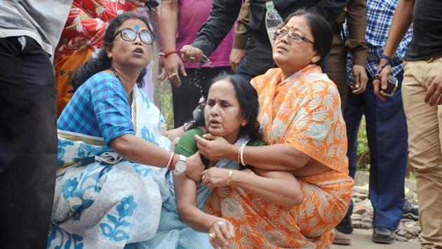 Women console a relative of the slain journalist in Agartala. Bhowmik, who worked with the Bengali newspaper, Syandan Patrika, and a news channel, Vanguard, as an investigative journalist had gone to the TSR’s 2nd battalion, for a story on Tuesday where he reportedly had an altercation with the commandant Tapan Debbarma and was shot by his personal guard Nandagopal Reang. (PTI) Women console a relative of the slain journalist in Agartala. Bhowmik, who worked with the Bengali newspaper, Syandan Patrika, and a news channel, Vanguard, as an investigative journalist had gone to the TSR’s 2nd battalion, for a story on Tuesday where he reportedly had an altercation with the commandant Tapan Debbarma and was shot by his personal guard Nandagopal Reang. (PTI)