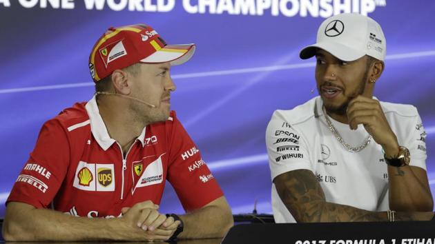 Ferrari driver Sebastian Vettel of Germany, left, looks to Mercedes’ Lewis Hamilton of Britain during a news conference at the Yas Marina racetrack in Abu Dhabi on Thursday. (AP) Ferrari driver Sebastian Vettel of Germany, left, looks to Mercedes’ Lewis Hamilton of Britain during a news conference at the Yas Marina racetrack in Abu Dhabi on Thursday. (AP)
