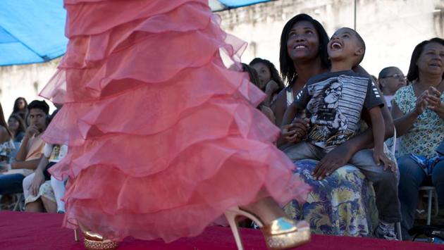 Inmates and their relatives watch female prisoners compete in the annual beauty contest in Brazil. After getting their hair and makeup done, 10 inmates were judged on their beauty, appeal and attitude as other inmates and relatives applauded. (Silvia Izquierdo / AP) Inmates and their relatives watch female prisoners compete in the annual beauty contest in Brazil. After getting their hair and makeup done, 10 inmates were judged on their beauty, appeal and attitude as other inmates and relatives applauded. (Silvia Izquierdo / AP)