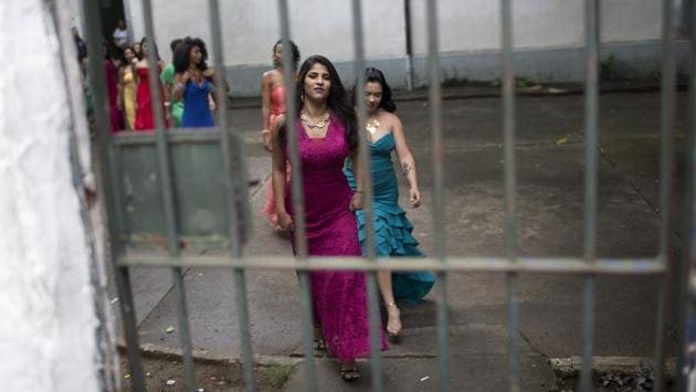 Female inmates wear evening gowns on the morning of the annual beauty contest at the penitentiary in Brazil. (Silvia Izquierdo / AP) Female inmates wear evening gowns on the morning of the annual beauty contest at the penitentiary in Brazil. (Silvia Izquierdo / AP)